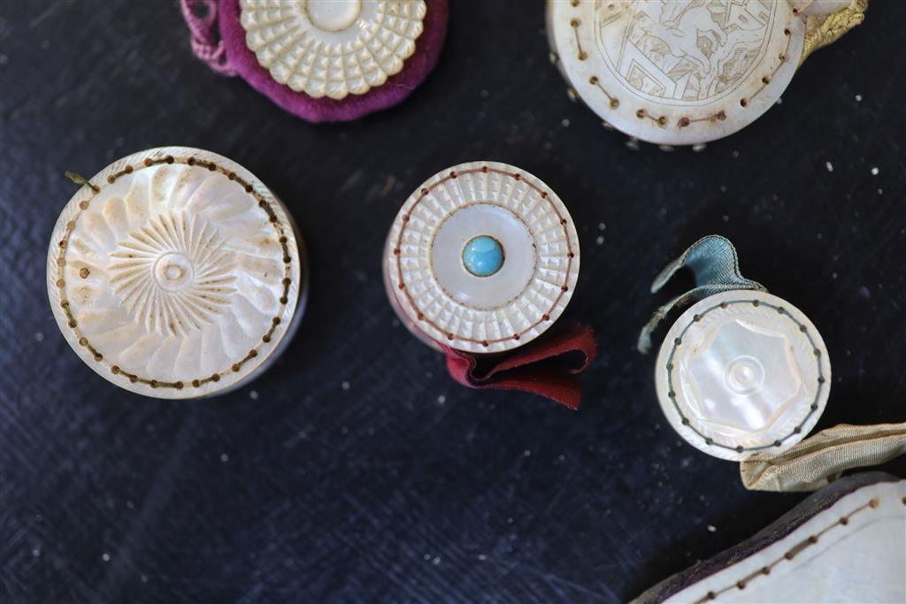 Eight assorted 19th century mother of pearl mounted pin cushions